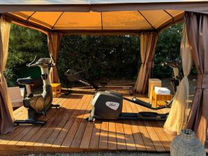 a gym with two exercise equipment in a tent at Hôtel L'Escalet in Ramatuelle