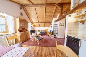 a kitchen and living room with wooden ceilings at Haus Antonia in Wallgau