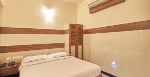 Postel nebo postele na pokoji v ubytování Hotel Kaveri Mahal