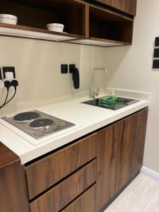 a kitchen with a stove and a sink at Studio Sulimaniyah in Riyadh +6 photos