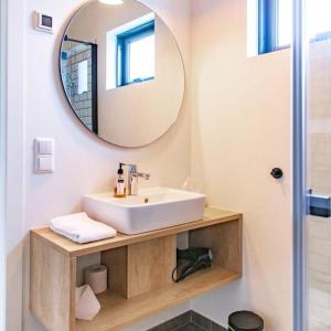 a bathroom with a sink and a mirror at Magma Hotel in Kirkjubæjarklaustur +55 photos