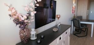 a black counter with a vase with flowers in a room at Hanseatenhaus in Westerland (Sylt) +53 photos