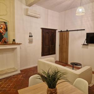 a living room with a couch and a table at Appartement centre ville de malaucene in Malaucène