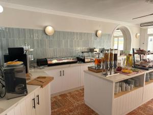 a kitchen with a counter with food on it at Hotel Paraíso Del Mar in Nerja