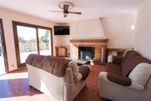 a living room with two couches and a fireplace at Casa Rural VILLA ADRISEDA in Constantina