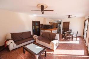 a living room with two couches and a table at Casa Rural VILLA ADRISEDA in Constantina
