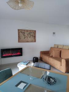a living room with a couch and a fireplace at studio rdc avec terrasse et parking privé in Agde +19 photos
