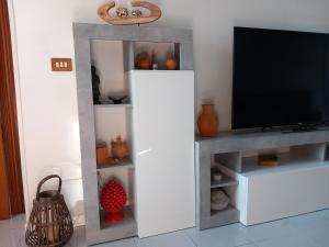 a living room with a tv on a white entertainment center at La Casa di Gio ed Eli in Voghera +73 photos