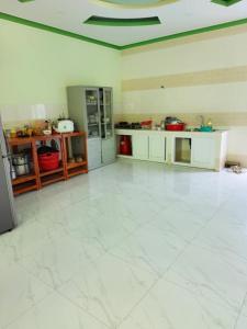 a large kitchen with a large white tile floor at Bình Minh Hotel Ninh Thuận in Ninh Hải