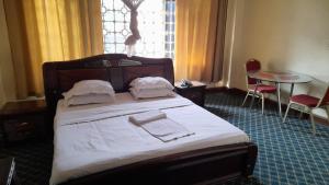 Postel nebo postele na pokoji v ubytování New JBK Hotel
