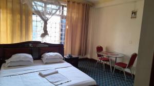 Postel nebo postele na pokoji v ubytování New JBK Hotel