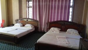 Postel nebo postele na pokoji v ubytování New JBK Hotel