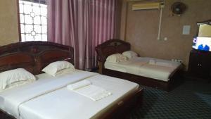 Postel nebo postele na pokoji v ubytování New JBK Hotel