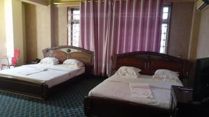 Postel nebo postele na pokoji v ubytování New JBK Hotel