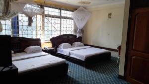 Postel nebo postele na pokoji v ubytování New JBK Hotel
