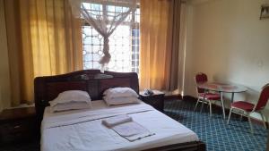 Postel nebo postele na pokoji v ubytování New JBK Hotel