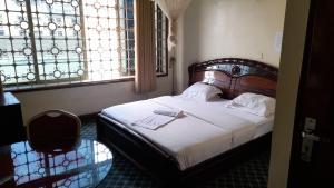 Postel nebo postele na pokoji v ubytování New JBK Hotel
