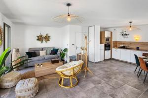 a living room with a couch and a table at Le Bronfleur in Bron