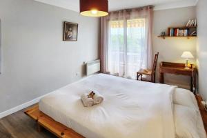 a bedroom with a large white bed with a box on it at Terrace Caluire in Caluire-et-Cuire