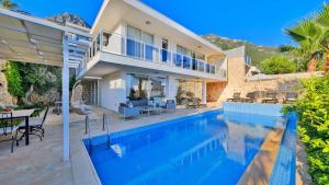 a villa with a swimming pool and a house at Kalkan 4 Bedroom Villa 6630 in Kalkan