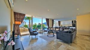 a living room with couches and chairs and a kitchen at Kalkan 4 Bedroom Villa 6630 in Kalkan