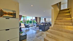 a living room with a staircase in a house at Kalkan 4 Bedroom Villa 6630 in Kalkan