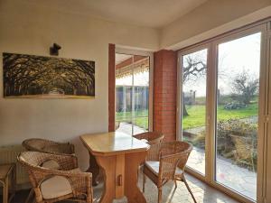 a dining room with a table and chairs and a window at Dat Bienenhuus in Putbus