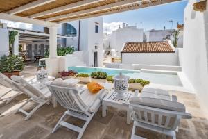 a patio with a table and chairs and a swimming pool at Relais Corte Palmieri & Il Chiostro - Residenza d'epoca in Gallipoli