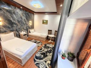 Katil atau katil-katil dalam bilik di Sherxan Hotel