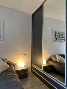 a bedroom with a large mirror next to a bed at I'M Apartment SILVER I centrum free parking in Bolesławiec