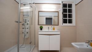 a bathroom with a sink and a shower with a mirror at Amaro Oasis by LovelyStay in Funchal +65 photos
