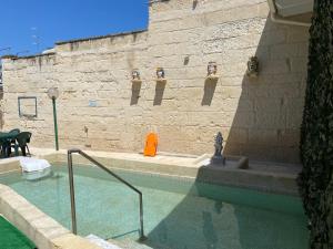a building with a pool of water in front of a wall at B&B Dimora Villa Orietta - Torre dell'Orso in Torre dell'Orso