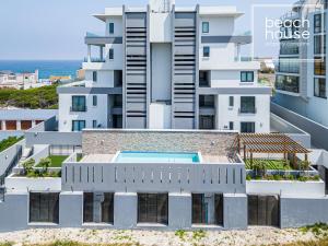an aerial view of a building with a swimming pool at Luxury Beachfront Penthouse, Blouberg- 3 Bedroom in Bloubergstrand