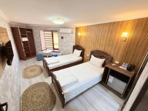 Katil atau katil-katil dalam bilik di Sherxan Hotel