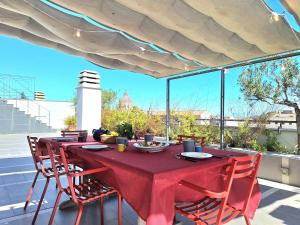 een rode tafel met stoelen op een patio bij Delmirani's Book Apartments - Vatican View in Rome