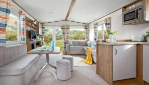a kitchen and living room in a caravan at WH - Smugglers Cove 02 in Aberaeron