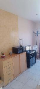 a kitchen with a stove and a microwave on a counter at Chambres chez l'habitant Coco2 in Boulazac