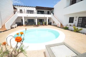 a swimming pool in front of a house at Sea Carnation Well Located, Pool & Terrace in Los Pocillos