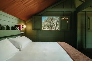 a bed in a room with a window at Braccialieri Luxury Resort in Avola +157 photos