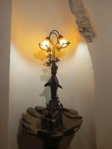 a statue of a woman on a table with a lamp at Casa Lola in Busquístar +16 photos
