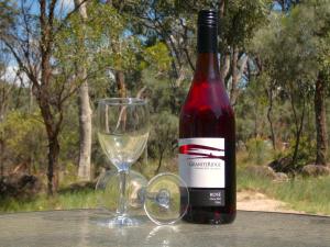 a bottle of wine and a glass on a table at Severn River Cottages in Severnlea