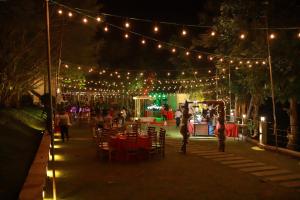 a group of people standing around a tent with lights at Grindlays Regency in Ambepussa +37 photos