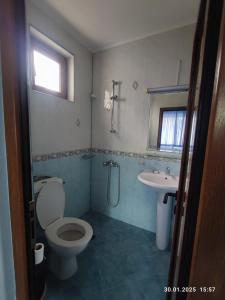 a bathroom with a toilet and a sink at Vila Victoria Primorsko in Primorsko