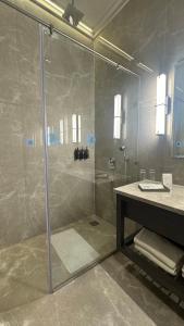 a bathroom with a shower and a sink at The Borgo in Ludhiana
