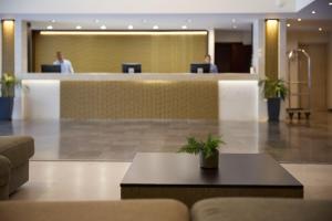 a lobby of a hotel with a reception desk at Blue Bay Beach Resort in Ialyssos +50 photos