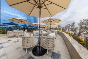 a patio with tables and chairs with umbrellas at Braira Hafar Al-Batin in Hafr Al Baten