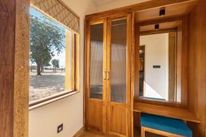 a room with a wooden door and a window at Sterling Rudraksh Jaisalmer in Jaisalmer