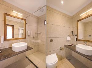 a bathroom with a sink and a toilet and a mirror at Sterling Rudraksh Jaisalmer in Jaisalmer