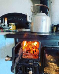 a tea kettle is sitting on top of an oven at Torpet Hagalund, Mariefred in Mariefred