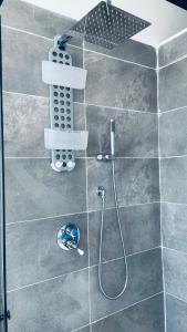 a shower with a shower head in a bathroom at Camera in centro storico in Olbia